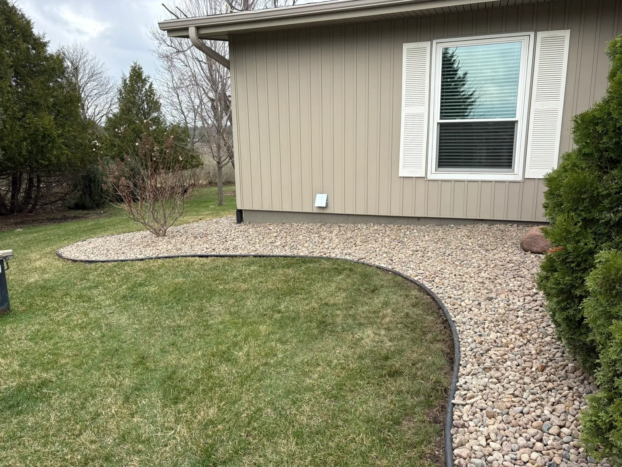 Residential outdoor rock bed project by Majerus Outdoor Services